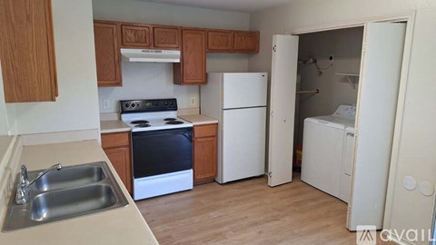 A kitchen with a white fridge and a stove top oven.