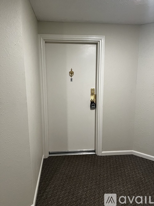 A room with a carpeted floor and a sliding glass door leading to a deck.