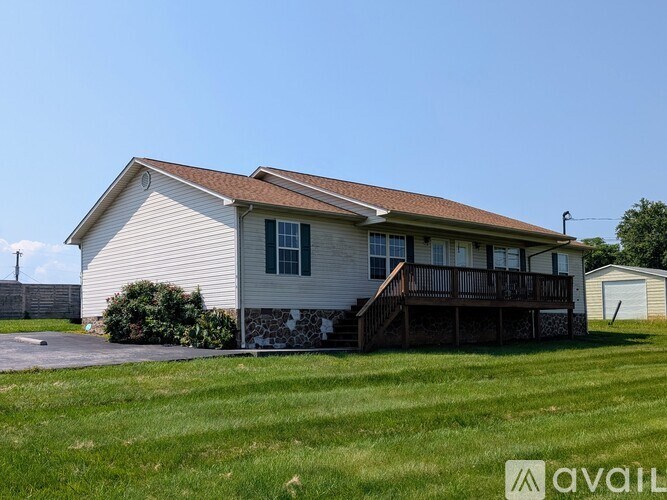 A house with a garage and a porch is available for rent.
