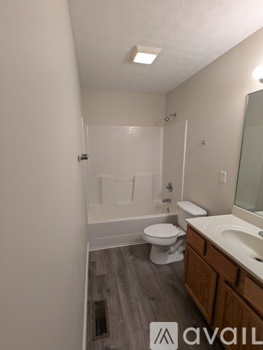 A bathroom with a toilet, sink, and bathtub.