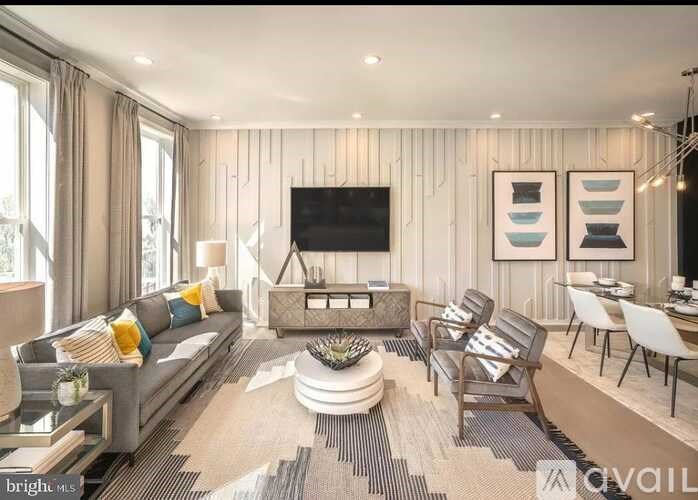 A living room with a grey sofa, a coffee table, and a television.