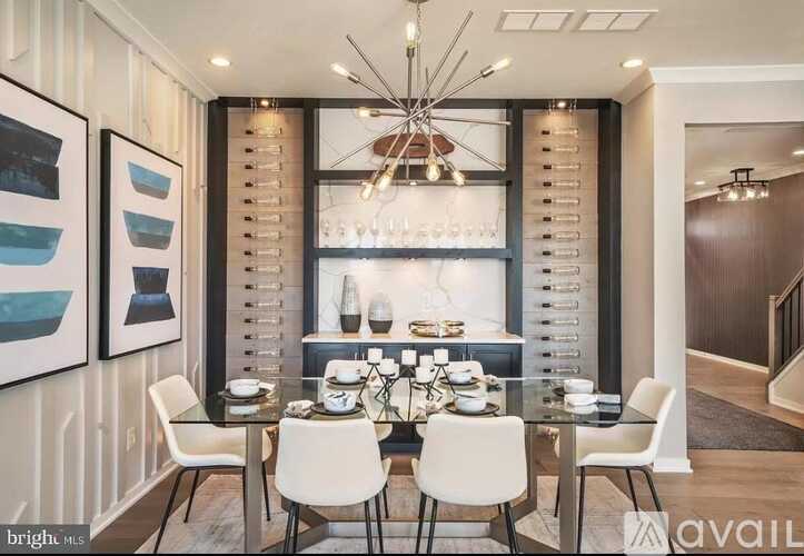 A modern dining room with a glass table and white chairs.