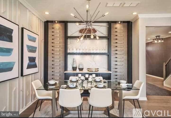 A modern dining room with a glass table and white chairs.