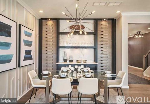 A modern dining room with a glass table and white chairs.