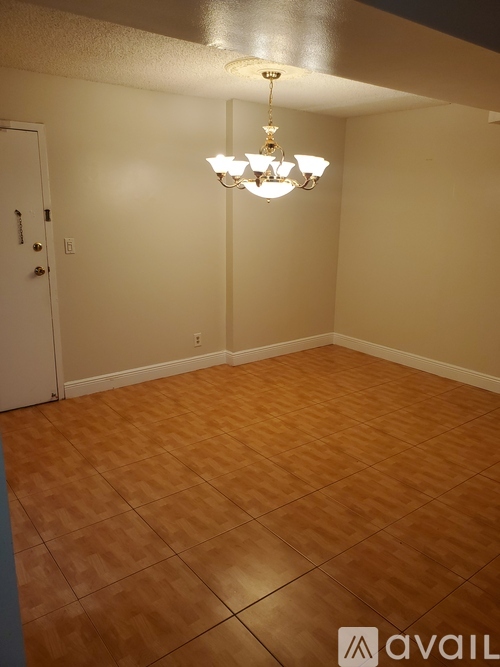 A room with a chandelier and a door.