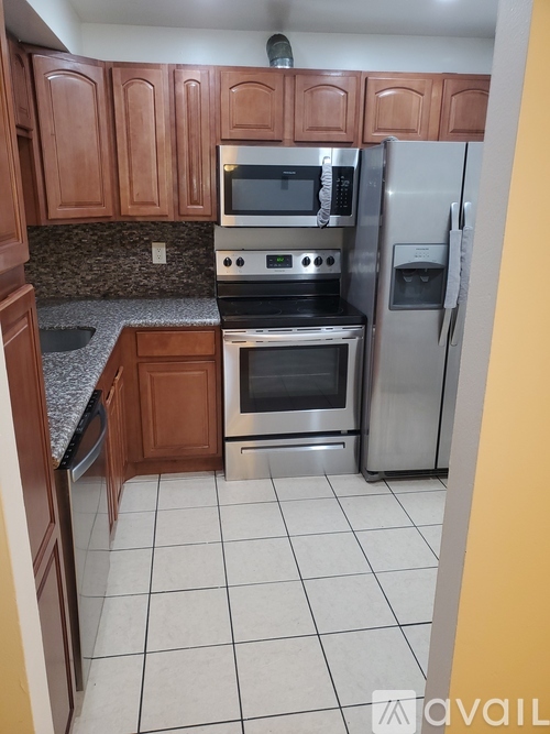 A kitchen with wooden cabinets and stainless steel appliances.