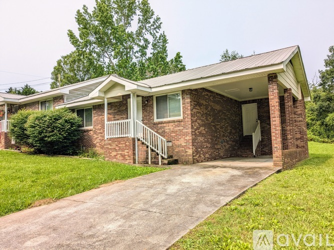 A house with a brick exterior and a covered porch.