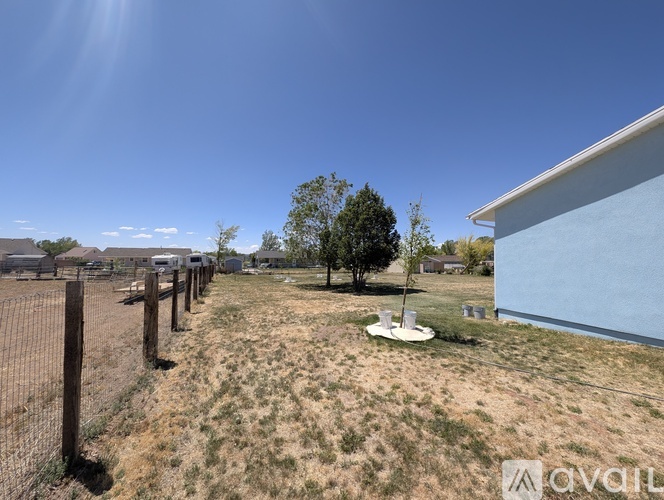 A blue house with a white garage door is for sale.