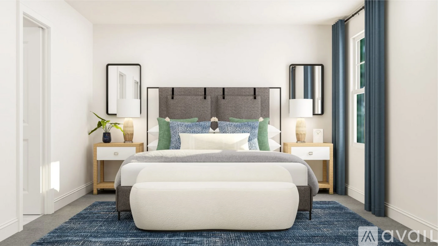 A bedroom with a large bed and two nightstands.