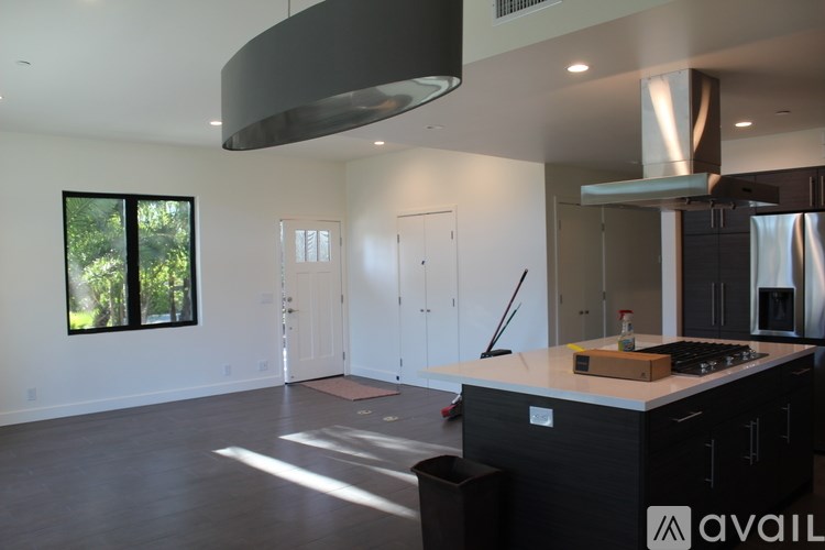 A modern kitchen with a large island and stainless steel appliances.