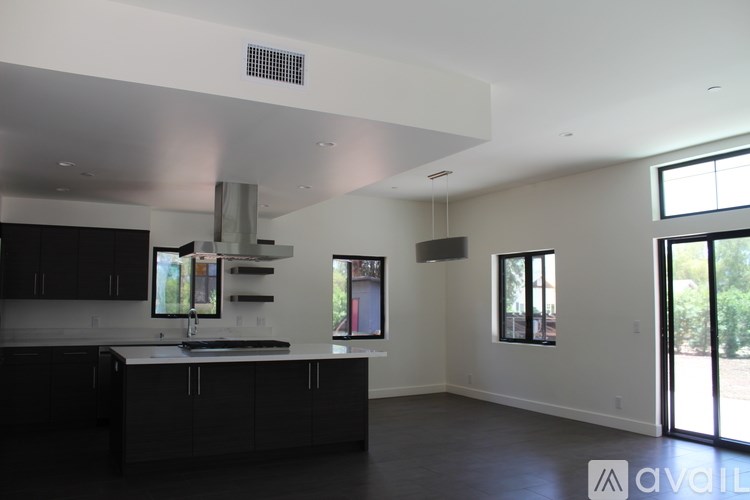 A room with a fireplace and sliding glass doors.