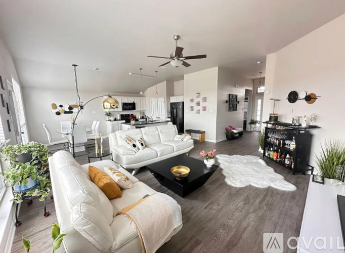 A living room with a white sofa and a black coffee table.