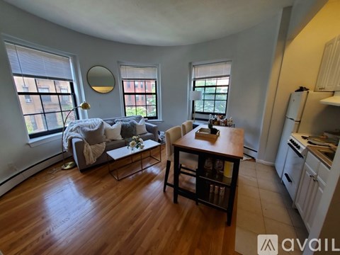 A living room with a grey couch and a wooden table.