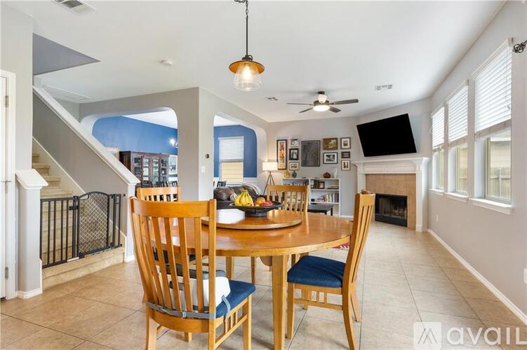 A dining room with a wooden table and chairs.