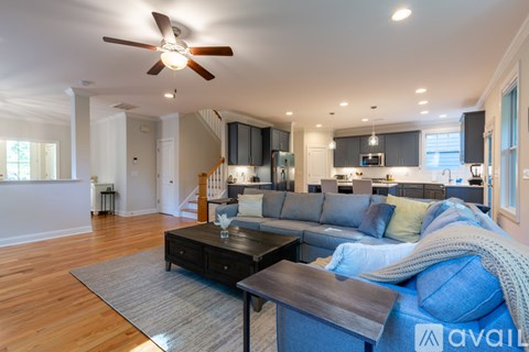 A living room with a blue couch and a wooden coffee table.