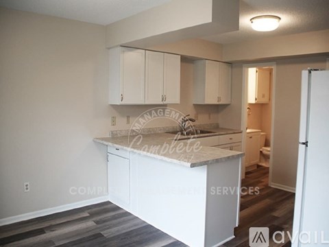A kitchen with white cabinets and a countertop.