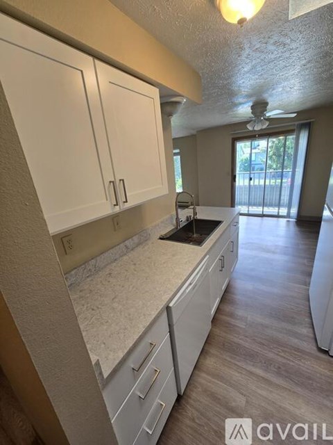 A kitchen with white cabinets and a countertop.