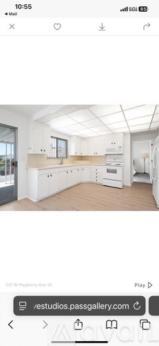 A spacious kitchen with white cabinets and a large island.