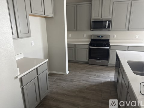 A kitchen with a dishwasher and a microwave.