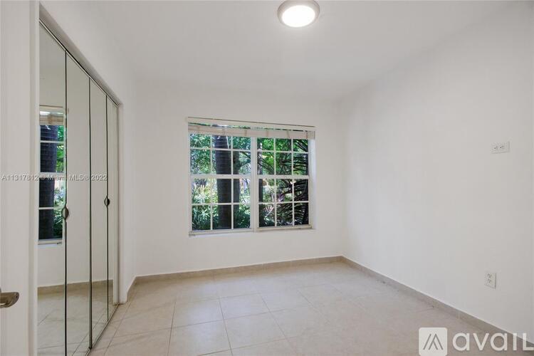 A room with a sliding glass door leading to a balcony.