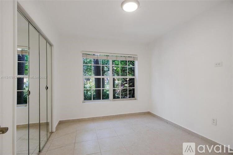 A room with a sliding glass door leading to a balcony.