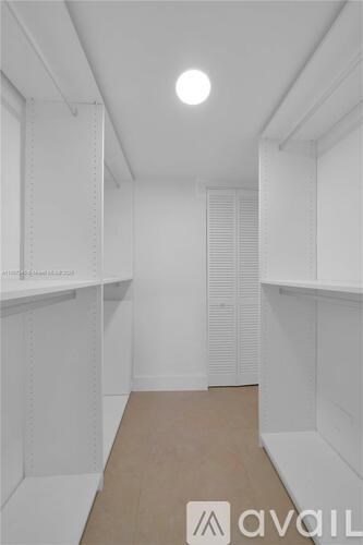 A white pantry with a light on the ceiling.