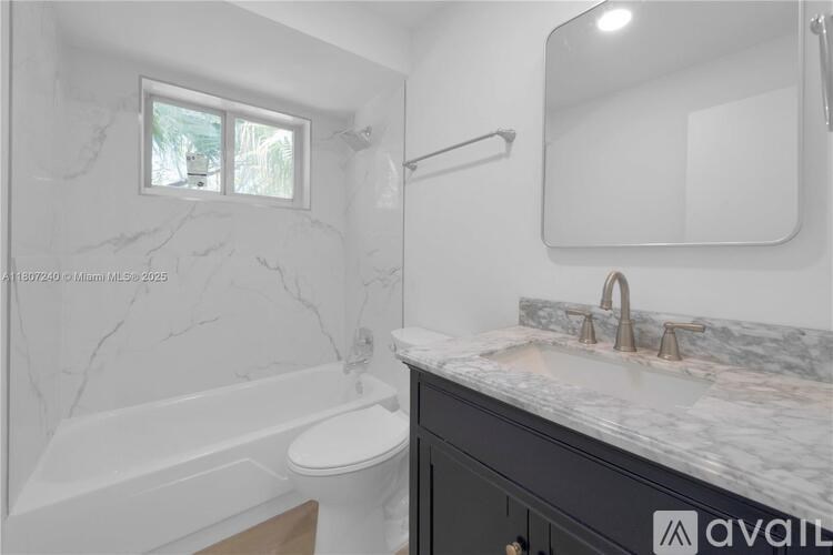 A bathroom with marble flooring and a large mirror.