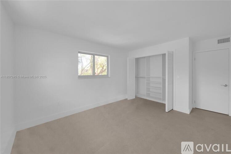 A room with a window and a door is available for rent.