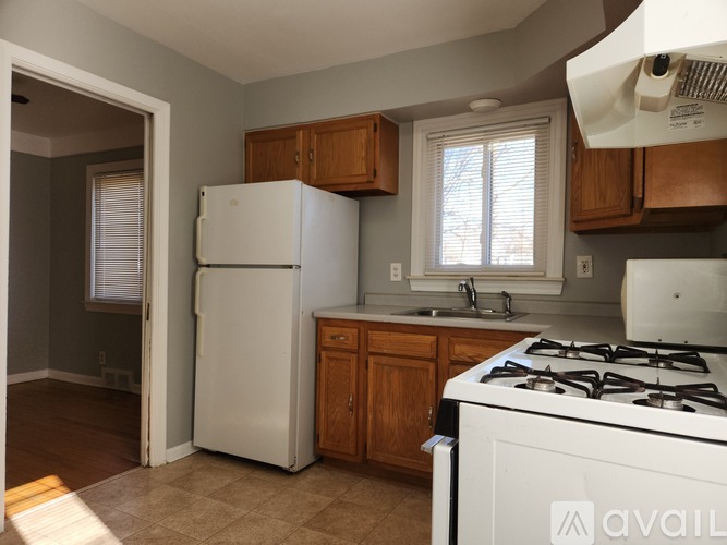 A kitchen with a white fridge and stove.