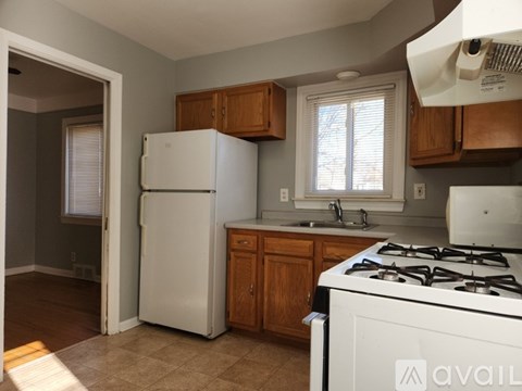 A kitchen with a white fridge and stove.