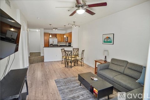 A living room with a grey couch and a coffee table.