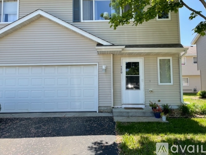 A house with a white garage door and a small front porch.