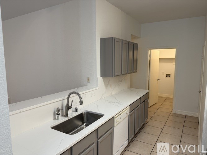 A kitchen with a sink and cabinets.