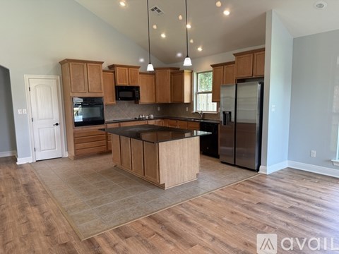 A kitchen with wooden cabinets and a central island.