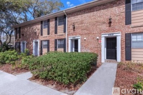 A brick building with a black door and windows.