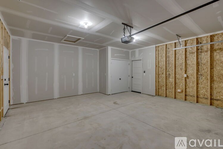 A spacious room with drywall on the walls and a ceiling fan.