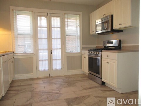 A kitchen with a microwave above the stove.