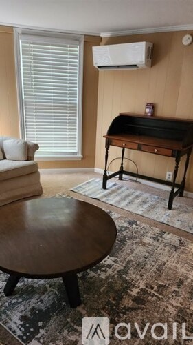 A living room with a piano and a couch.