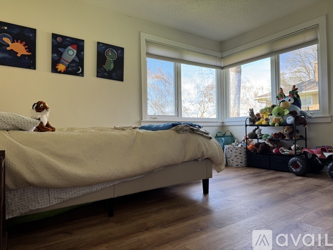 A baby nursery with a crib, a changing table, and a chair.