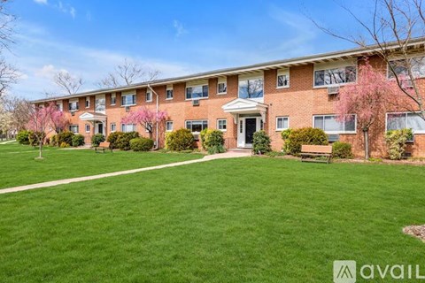 A building with a green lawn in front of it.