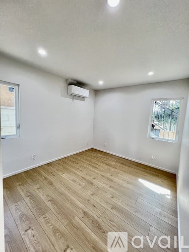 A room with wooden flooring and a window.