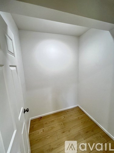 A room with a wooden floor and white walls.