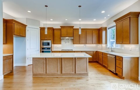 A modern kitchen with wooden cabinets and a central island.