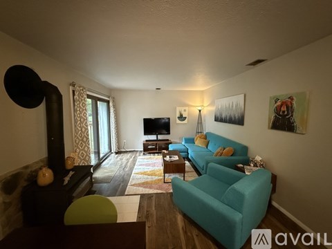 A living room with a blue couch and a television.