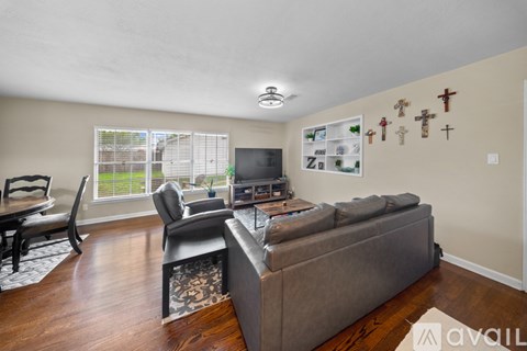 A living room with a grey couch and a television.