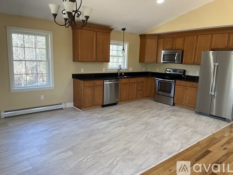 A kitchen with wooden cabinets and a refrigerator.