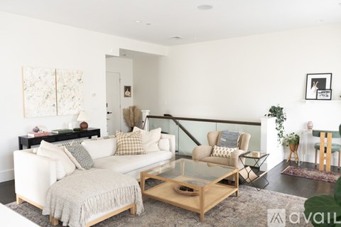 A living room with a white couch and a coffee table.