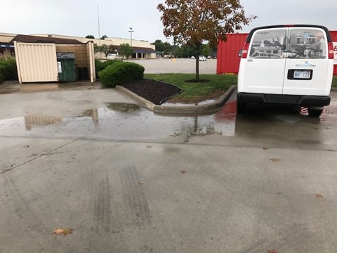 A white van is parked in a parking lot.