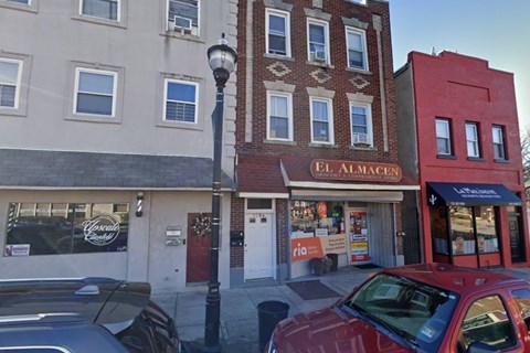 A street view of a building with the sign "El Almacen" on it.