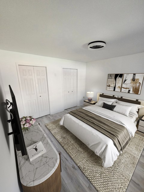 A bedroom with a large bed and a television on a stand.